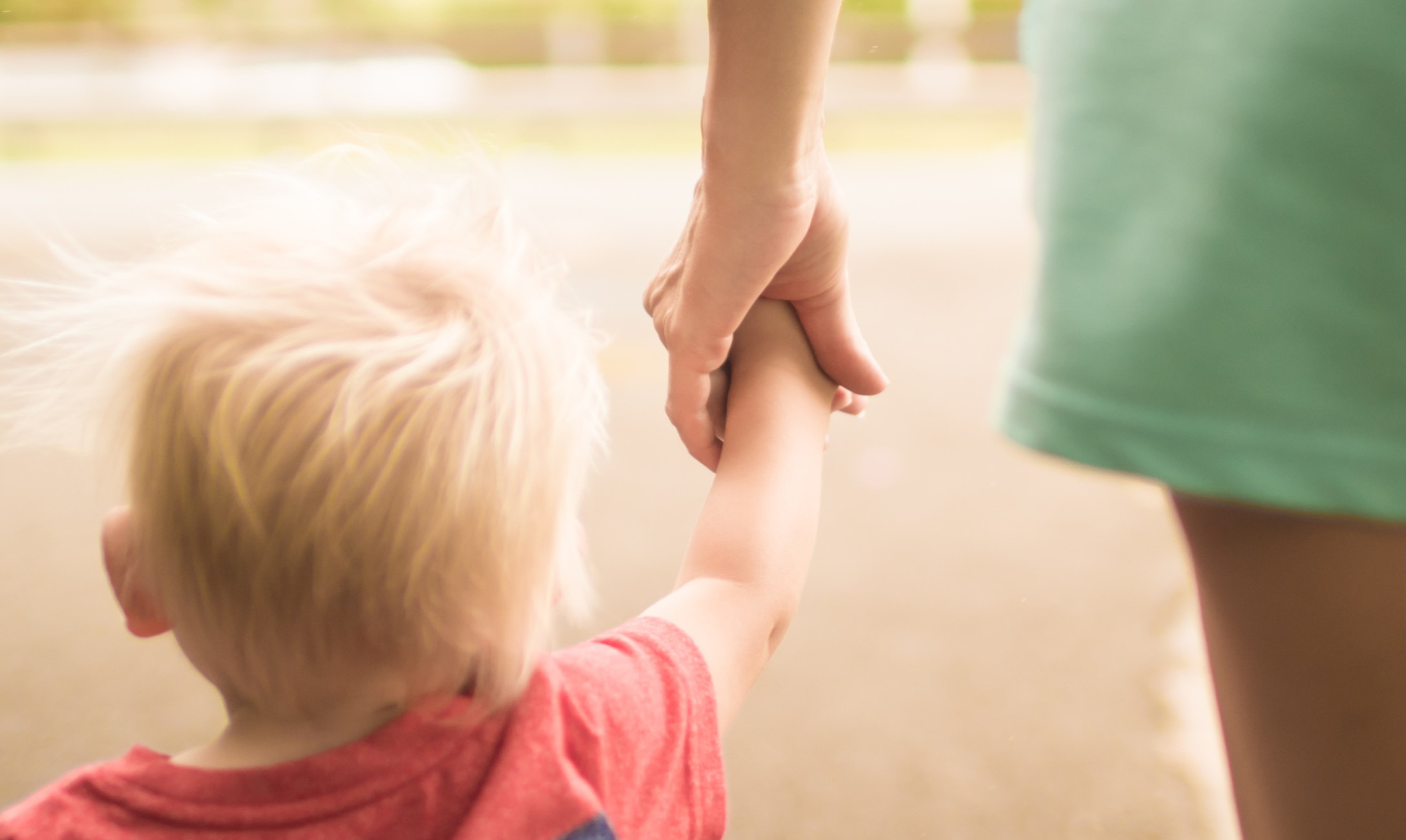 toddler boy holding hand