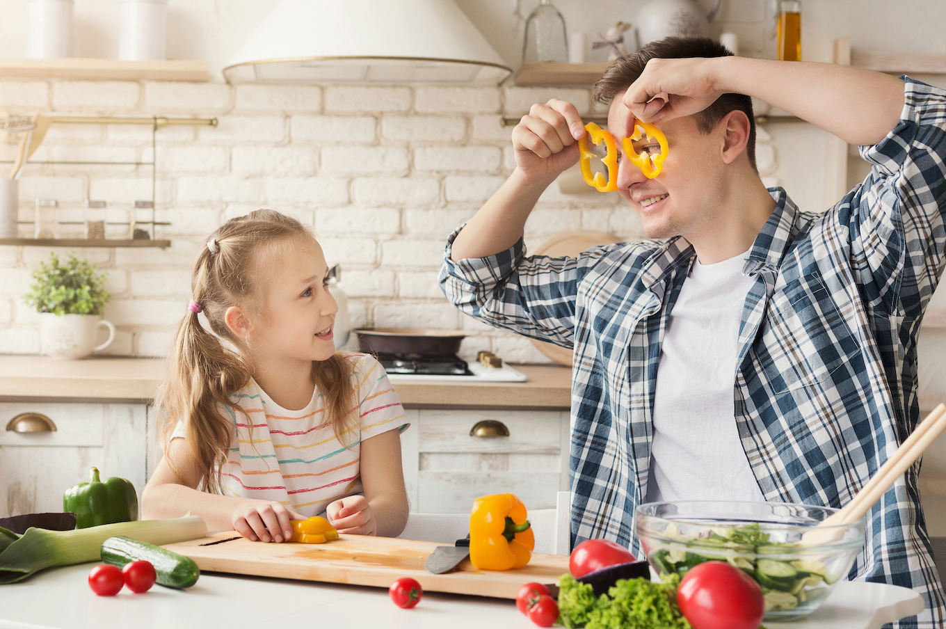 Happy father and his daughter having fun at kitchen