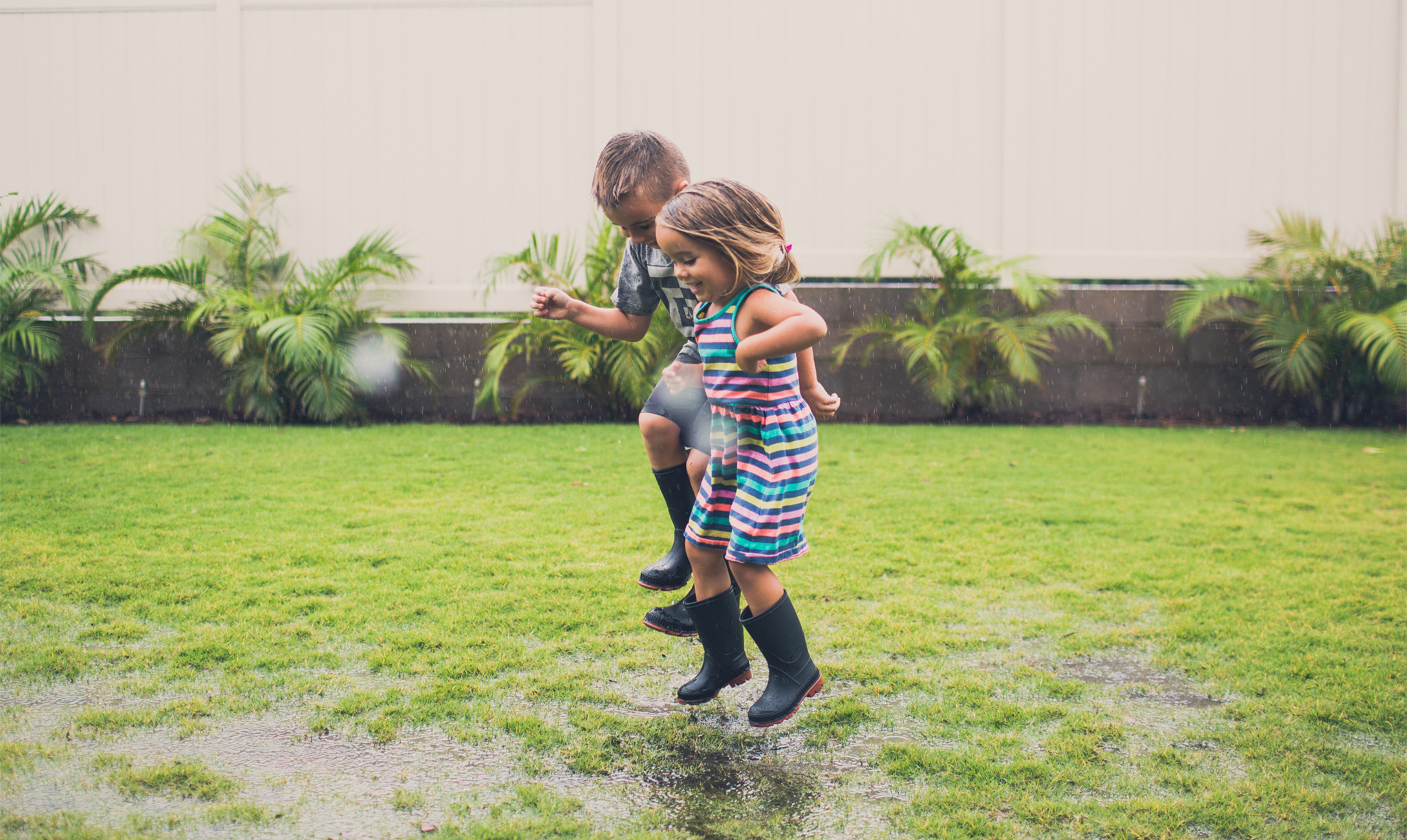 Kids jumping in puddles