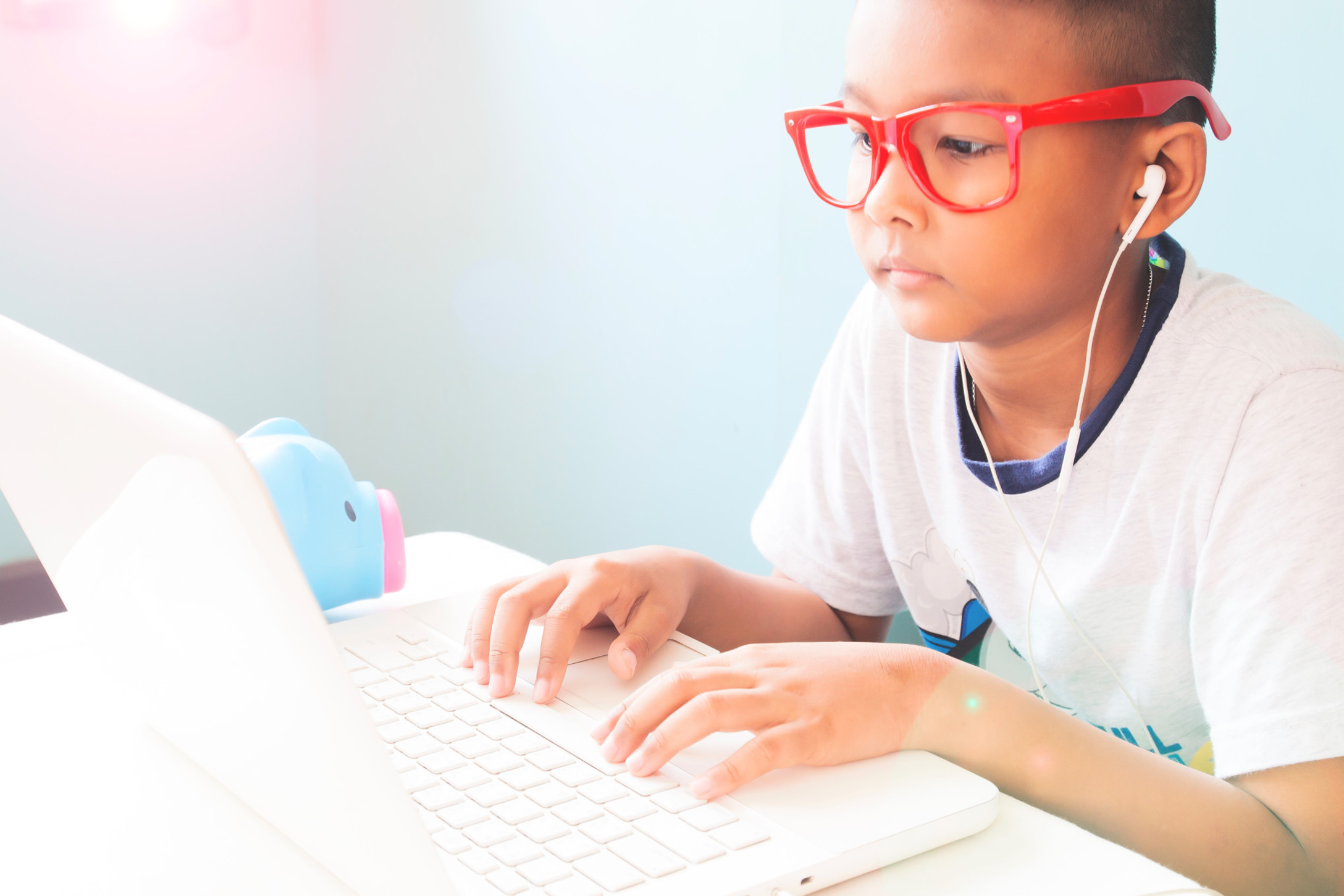 little-boy-listening-and-using-laptop-computer_t20_BE6pYY.jpg