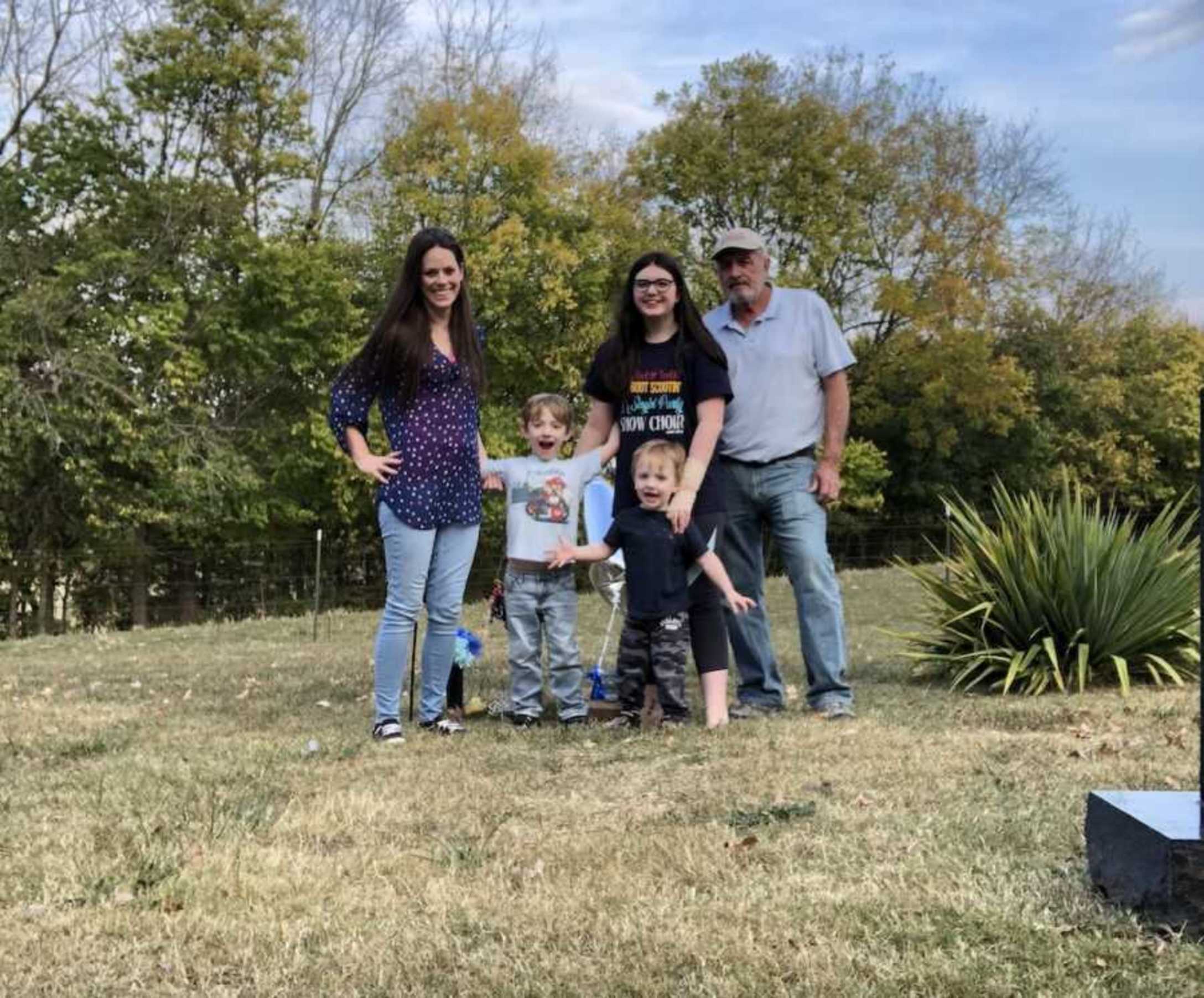 loss-mom-with-family-at-sons-grave-900x746-1.jpeg