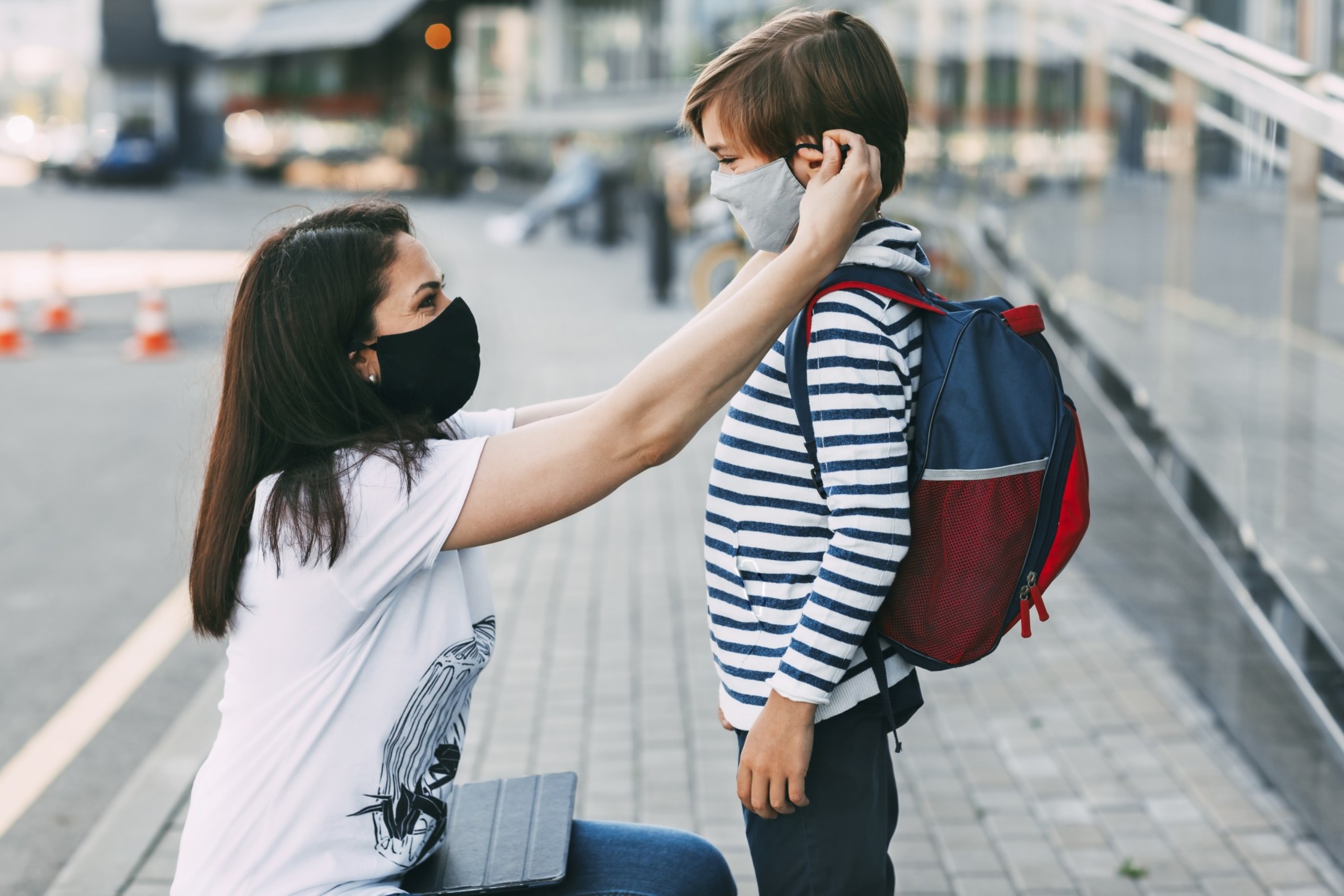 mother-adjusts-her-sons-mask-a-mother-and-child-on-their-way-to-school-or-kindergarten-during-a_t20_ynp9e0.jpg