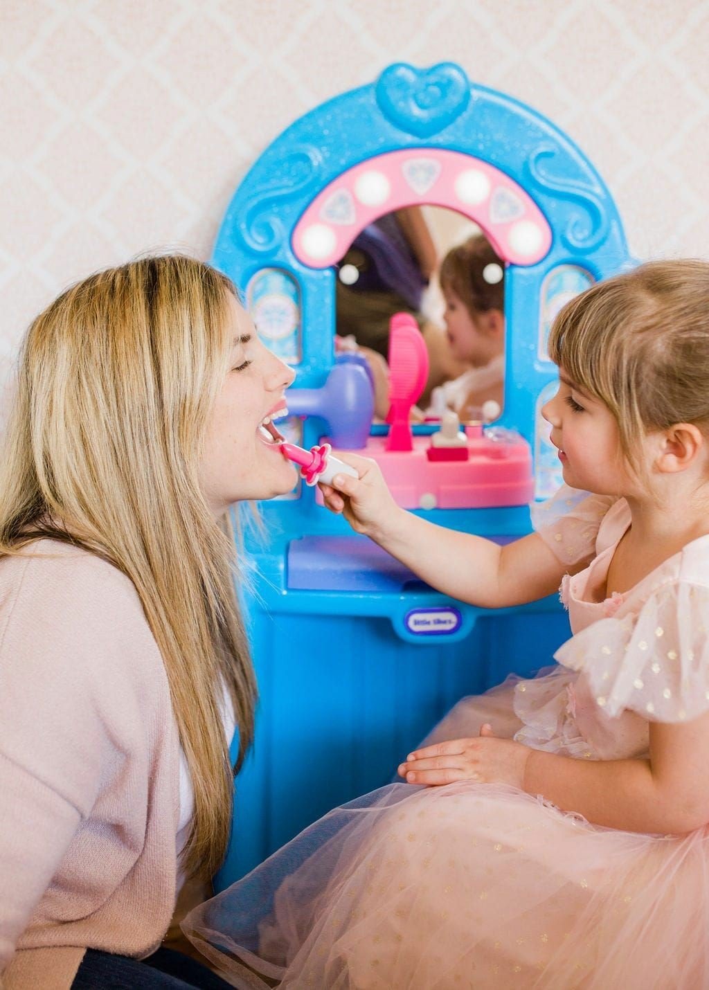 mom and daughter playing with Little Tikes toy makeup