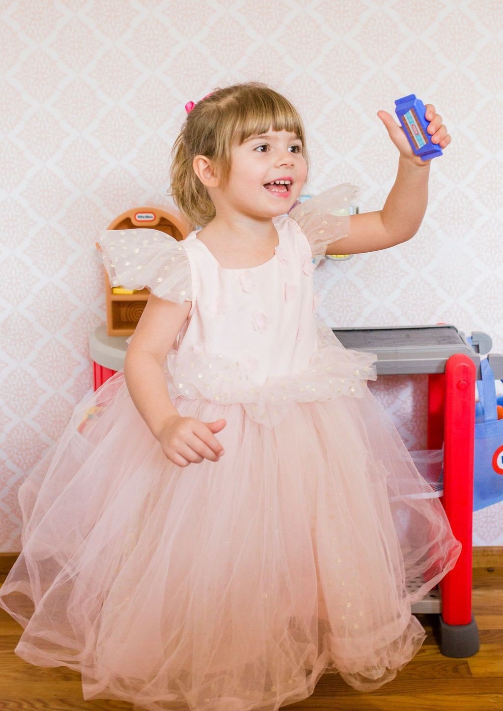 little girl playing with Little Tikes grocery store