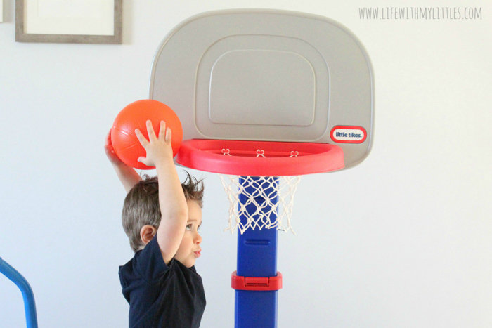 Toddler playing with Little Tikes basketball