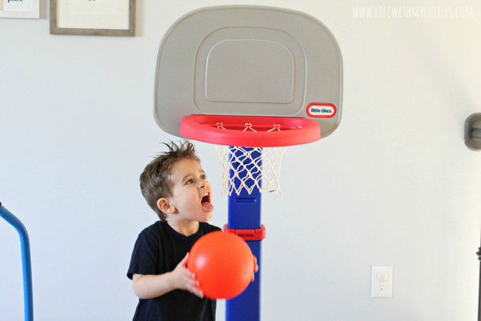 Toddler playing with Little Tikes basketball