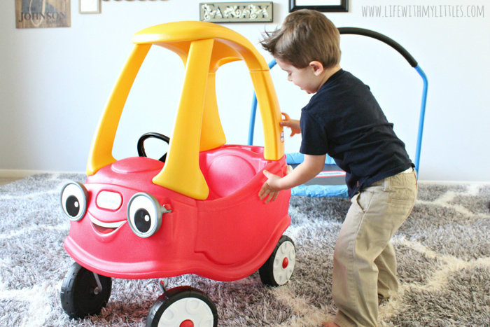 Toddler playing with Cozy Coupe