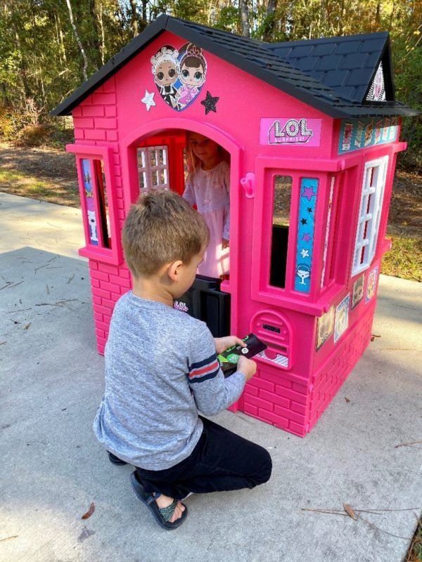 Little boy and little girl playing with LOL Surprise Cottage Playhouse
