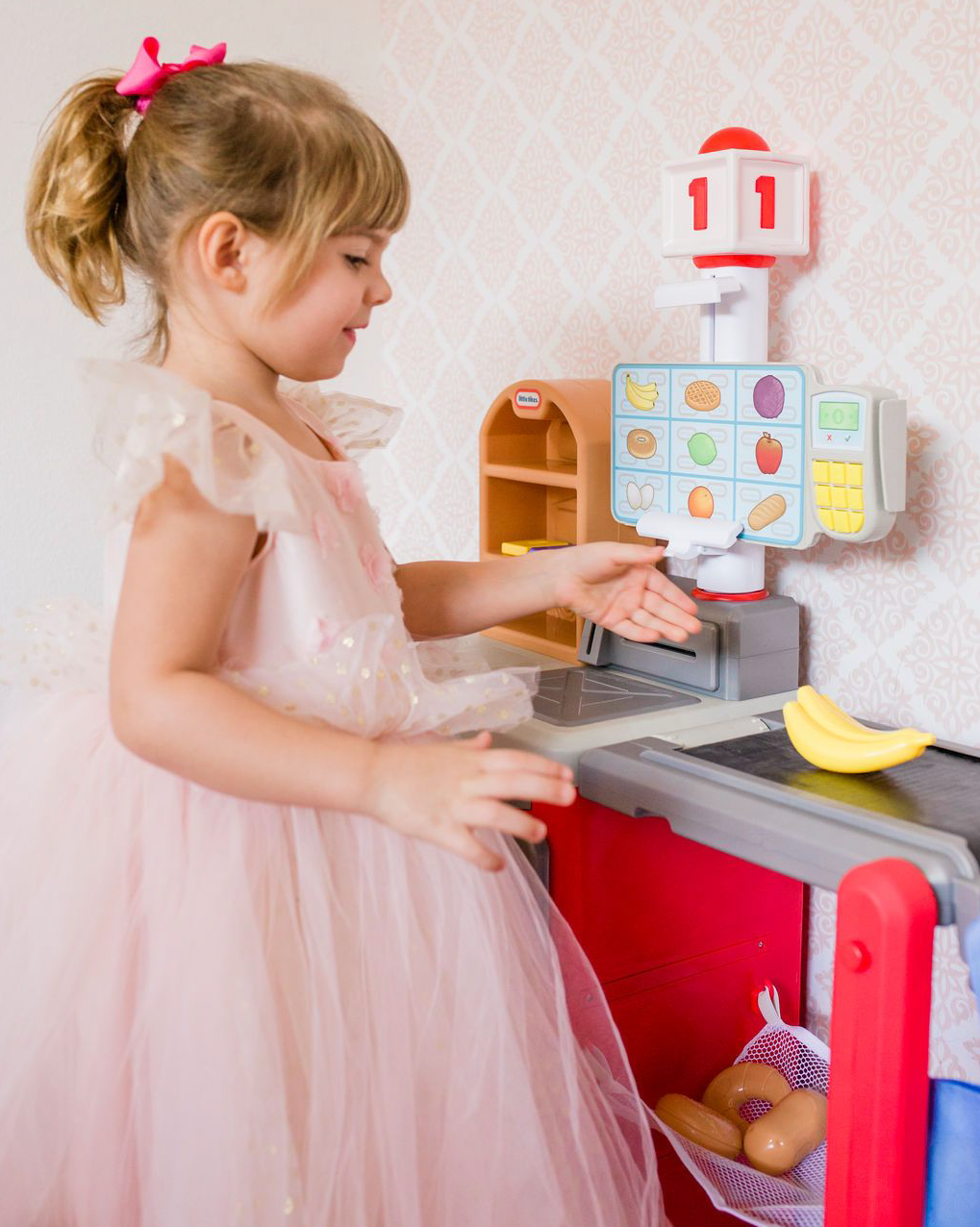 little girl playing with Little Tikes smart checkout