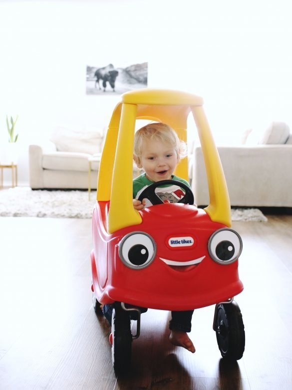 Toddler driving Cozy Coupe