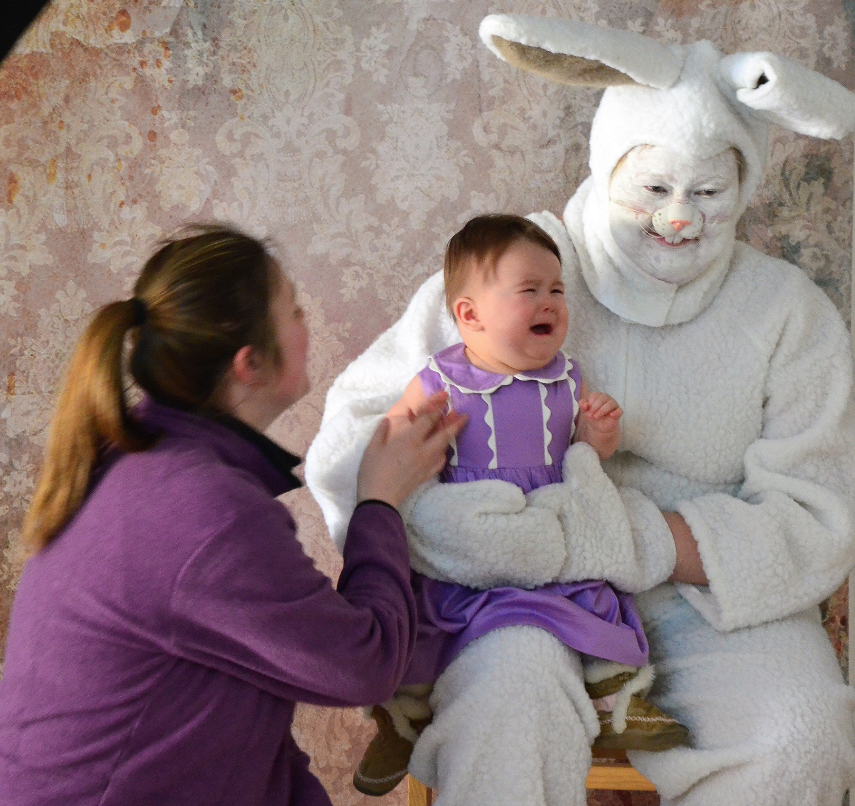 smiling easter bunny with crying baby