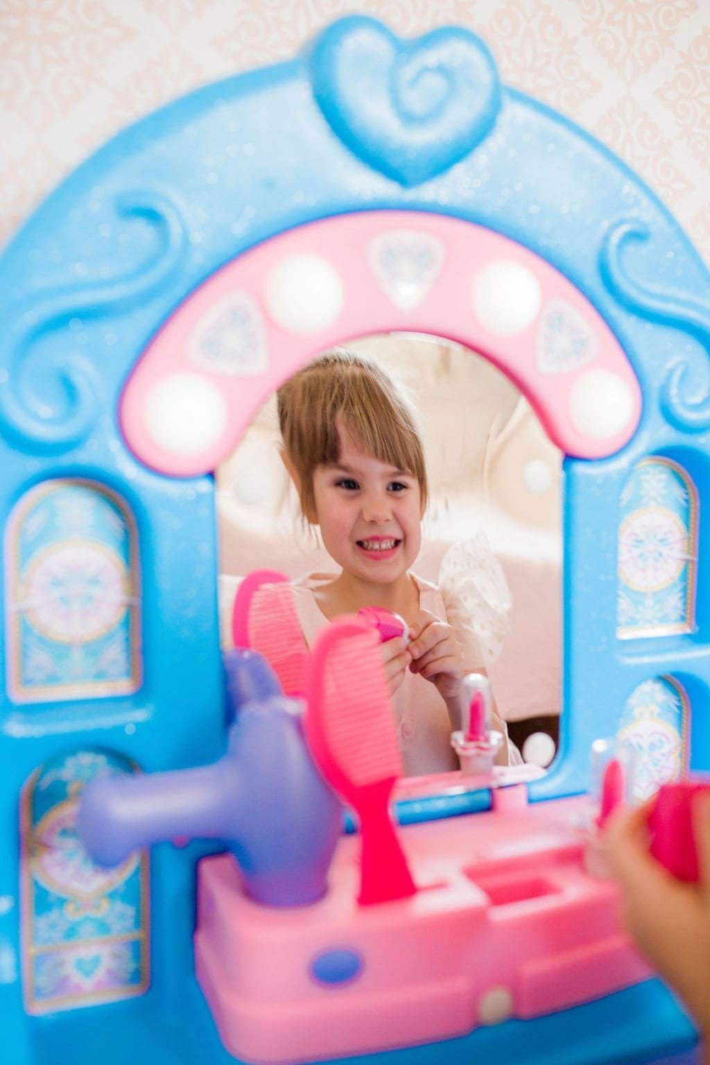little girl looking into Little Tikes Ice Princess Magic Mirror