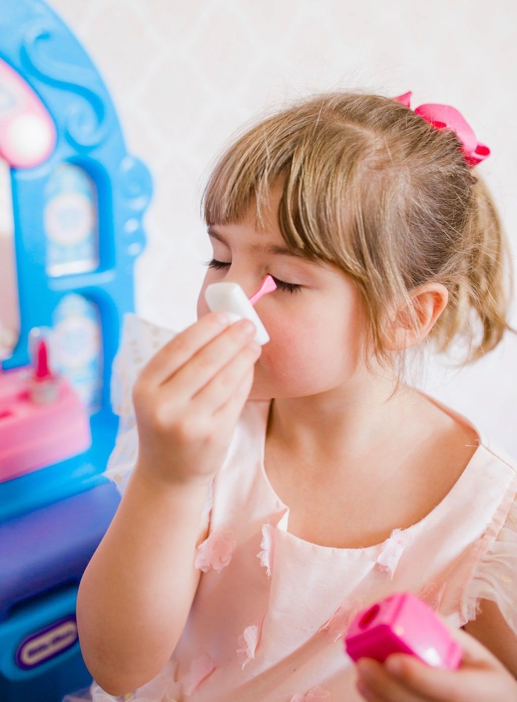 little girl playing with Little Tikes Ice Princess Magic Mirror play makeup