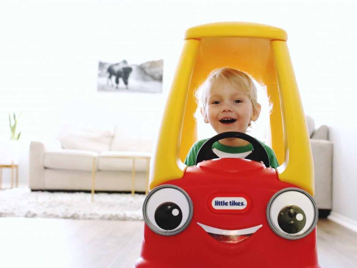Toddler driving Cozy Coupe