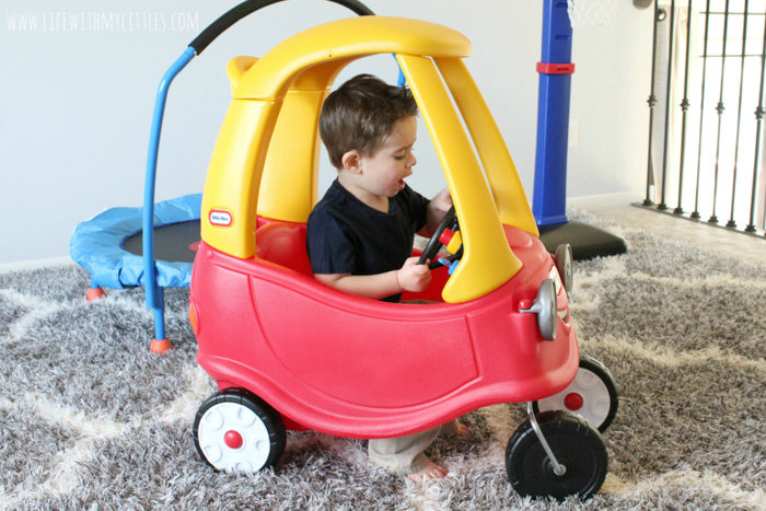 Toddler driving Cozy Coupe
