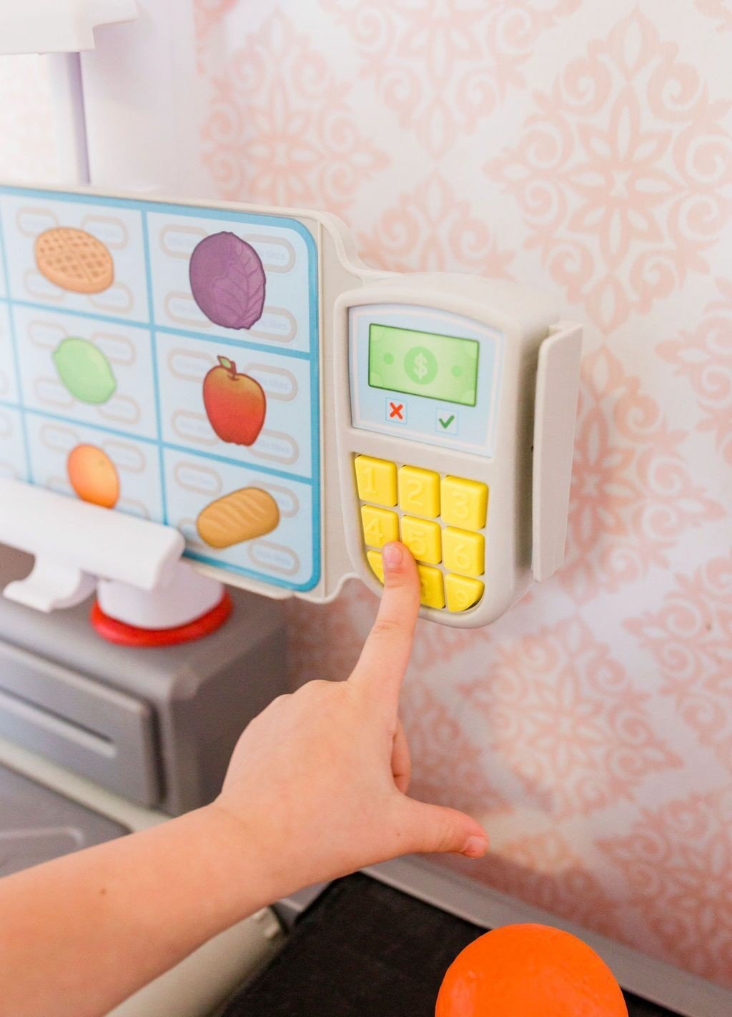 pushing buttons on the Little Tikes Shop 'n Learn