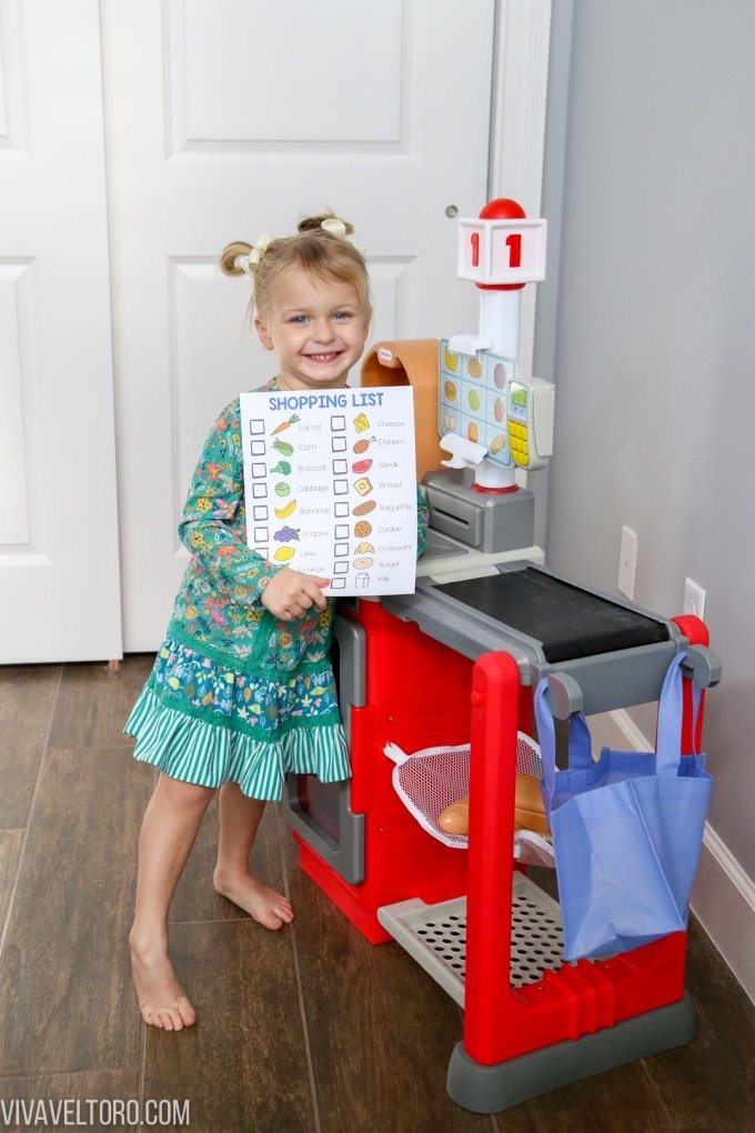Little girl holding pretend shopping list