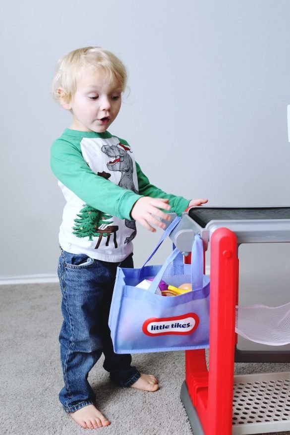 Happy toddler with Little Tikes grocery bag