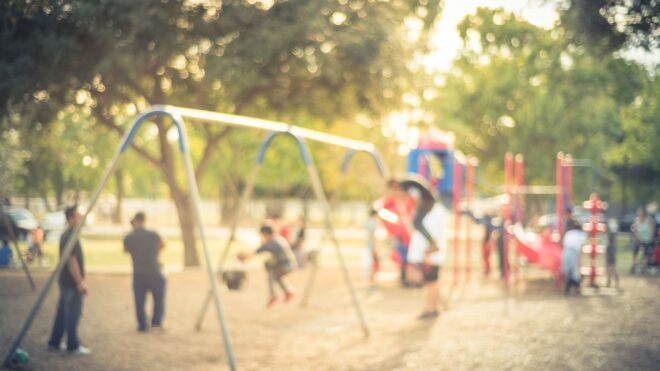 playground with family on swings and slide