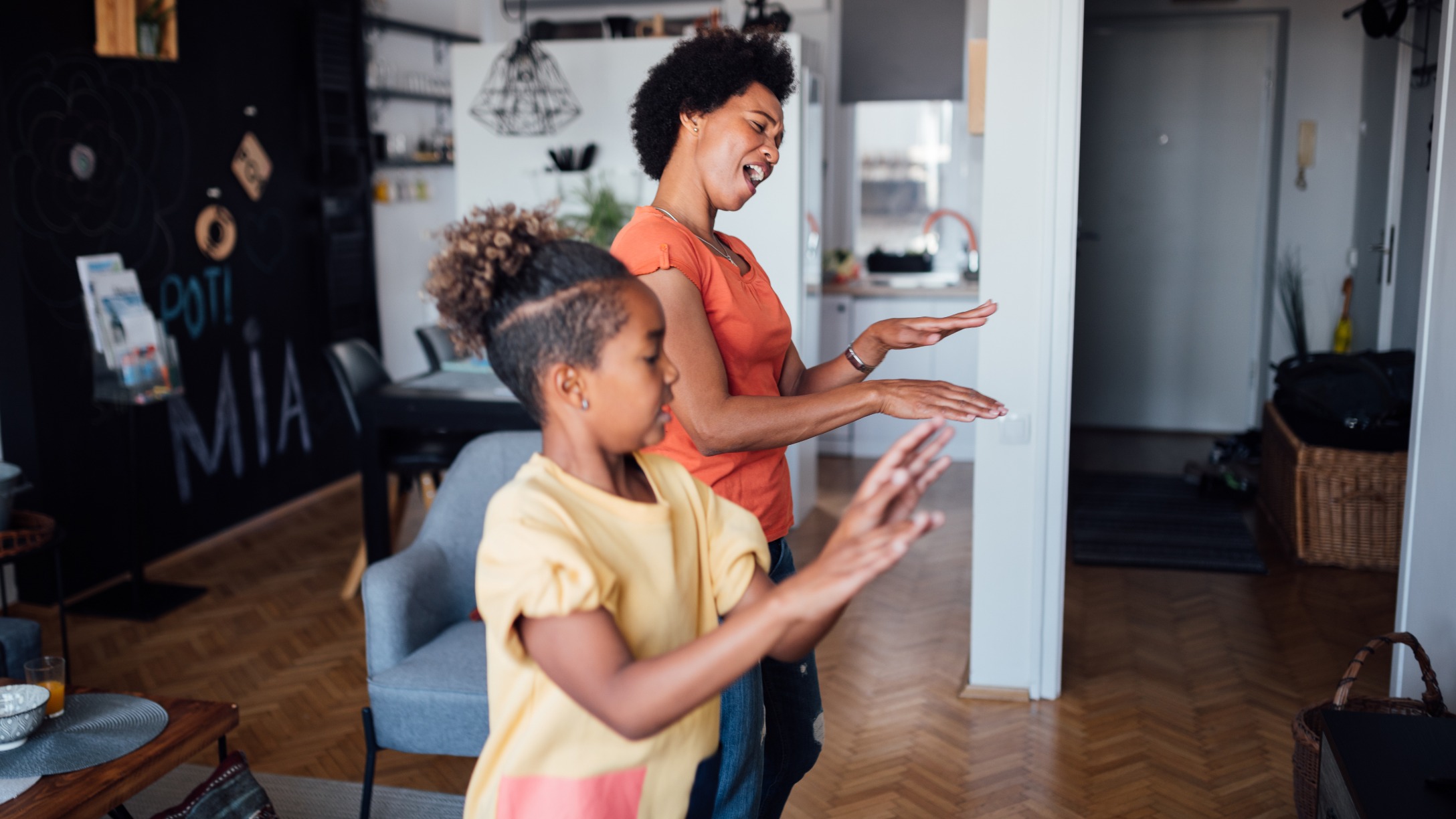 side-view-of-a-mother-and-daughter-dancing-at-home-picture-id1224702125.jpg