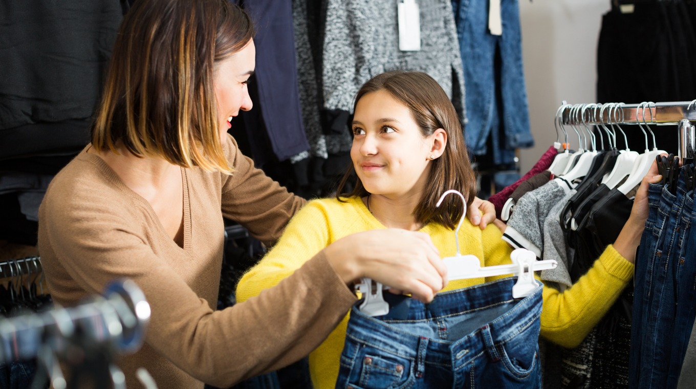 smiling-mother-and-daughter-are-looking-for-pairs-of-jeans-picture-id648920986.jpg