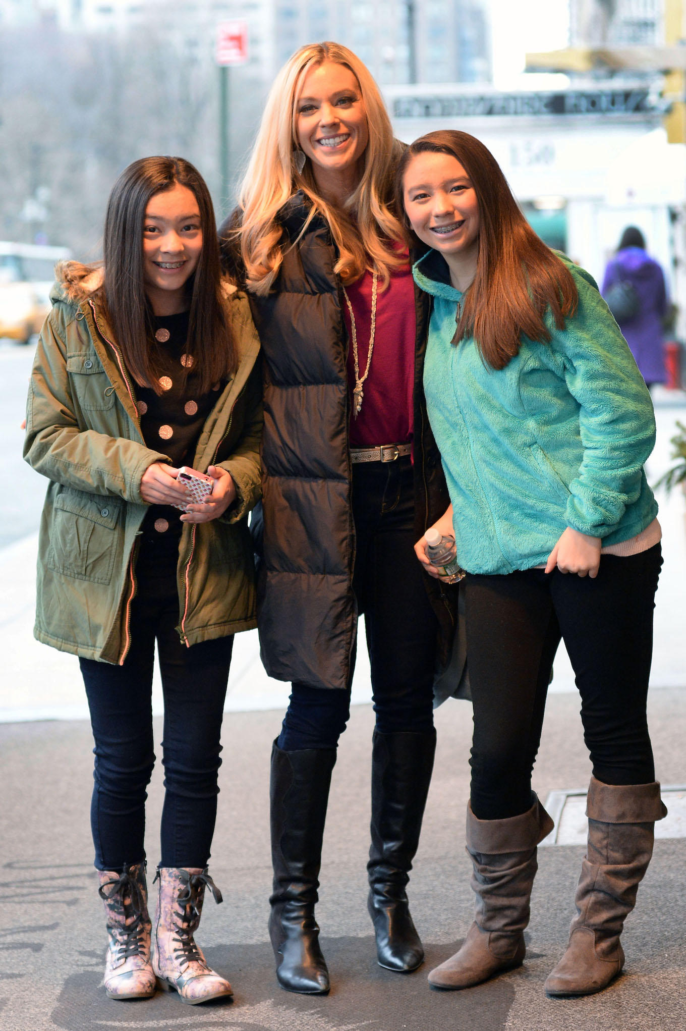 Kate Gosselin and her twin daughters greet two dogs at their Manhattan hotel