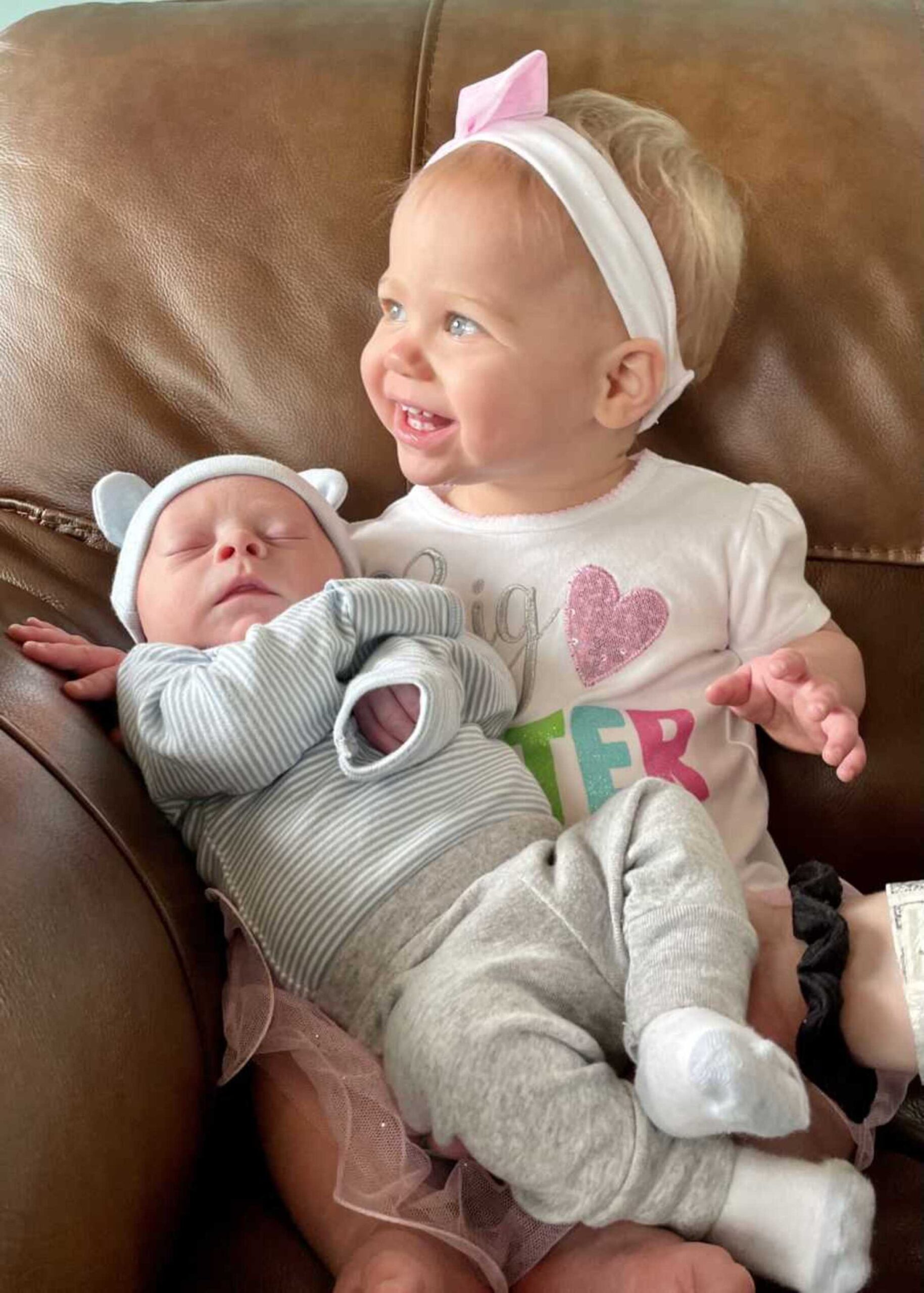 toddler-sister-with-newborn-brother-sleeping-in-lap-900x1260-1.jpeg