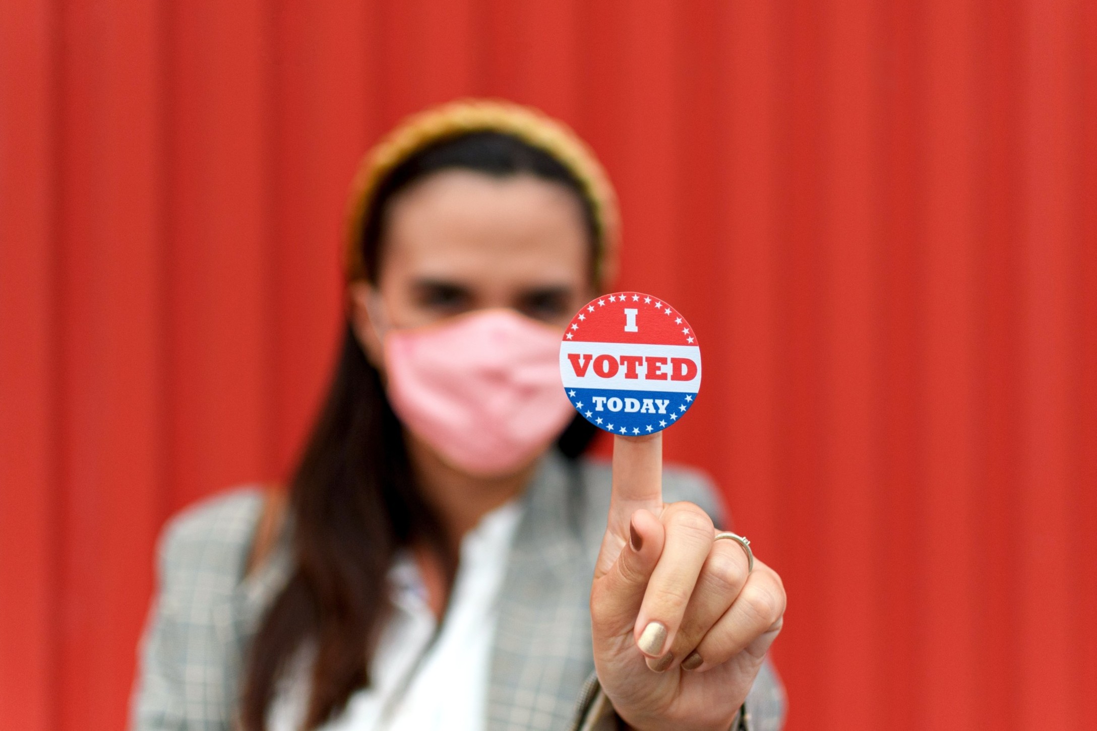 young-woman-with-protective-face-mask-holding-a-voting-sticker-on-her-finger-selective-focus-hand_t20_9kzG8N-1.jpg
