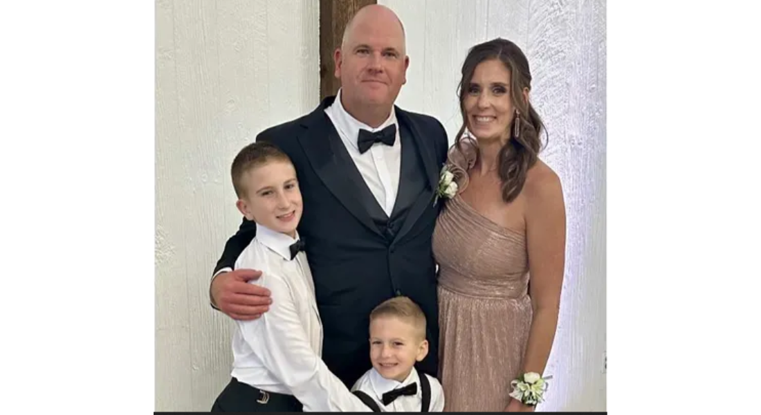 Ashley DeSkeere with her husband and two sons dressed in formal clothes