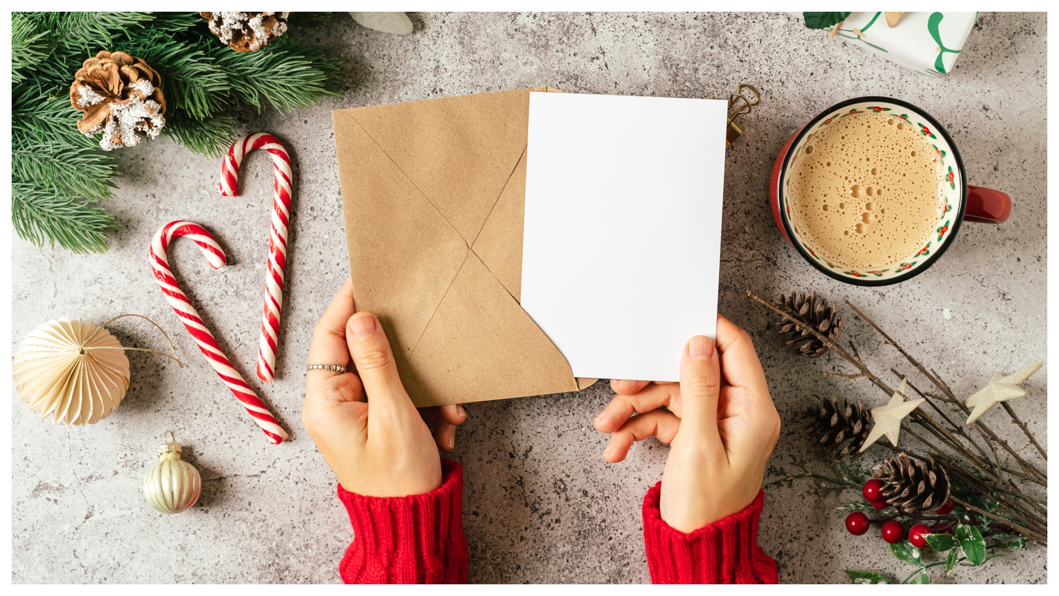 hands putting together a Christmas card