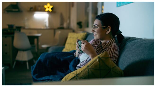 Cozy woman watching tv