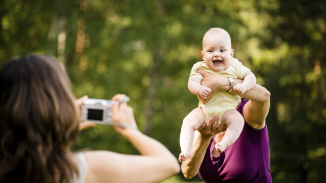 woman taking a picture of her baby