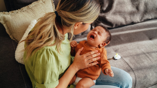 Mom holding crying baby