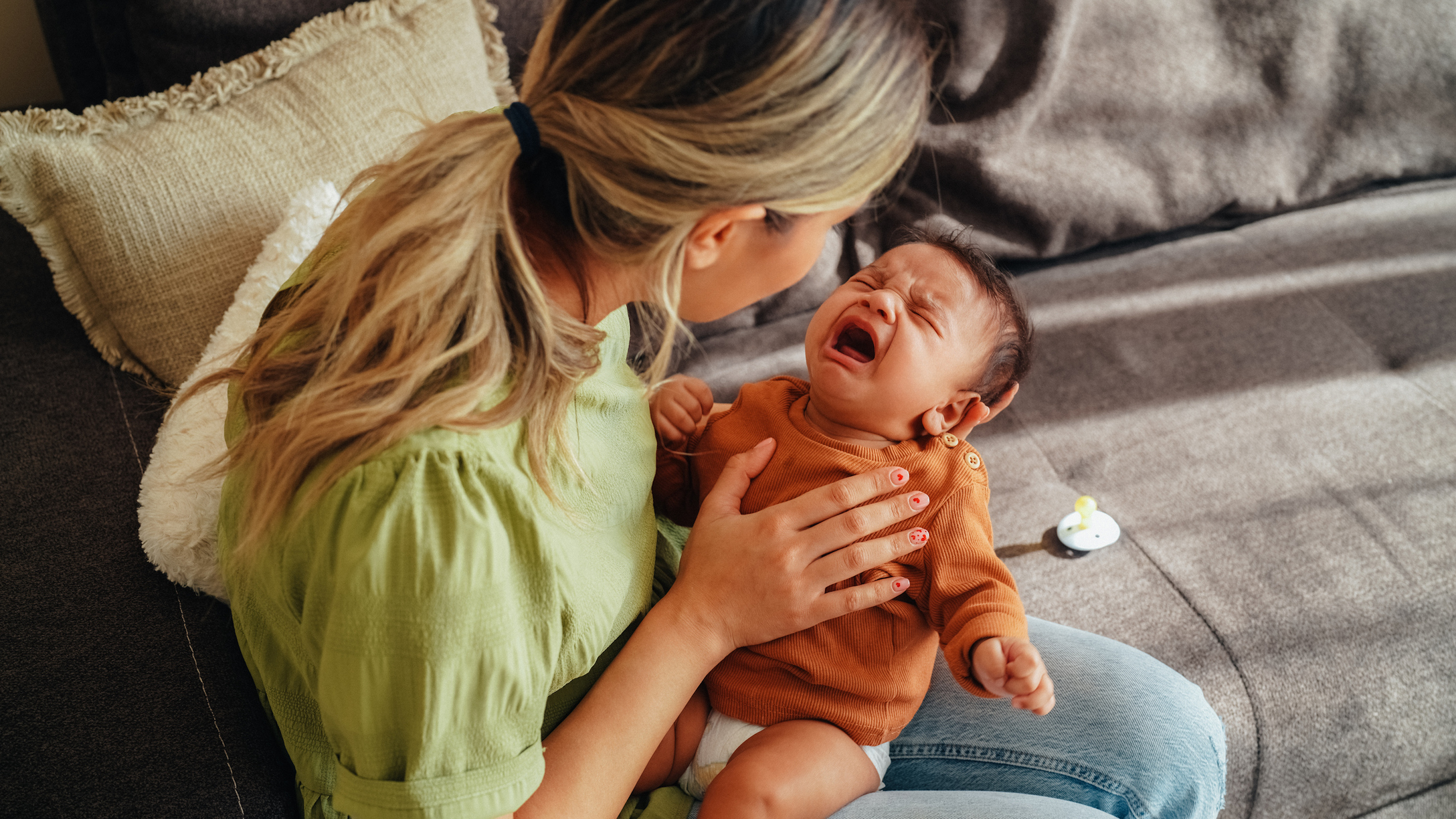 Mom holding crying baby