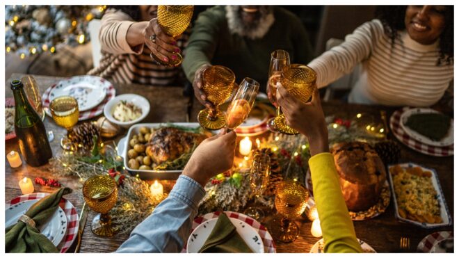 Family cheers at holiday meal, christmas party food