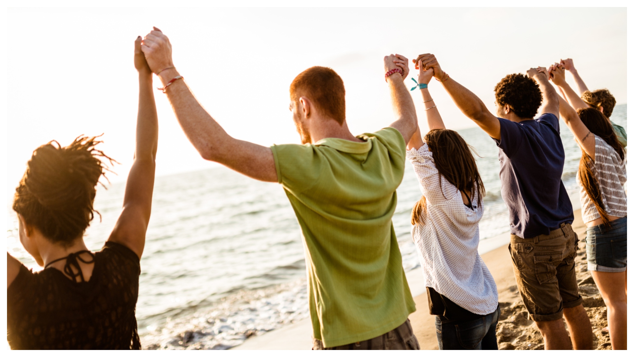 Family holding hands on beach