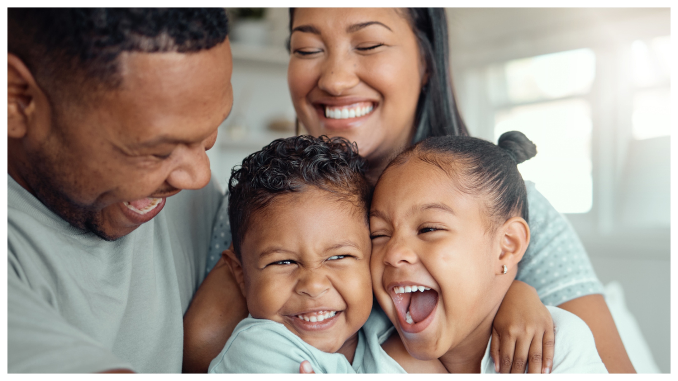 Family laughing together and hugging