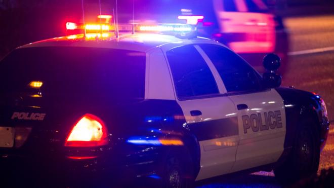 police car driving with its lights on