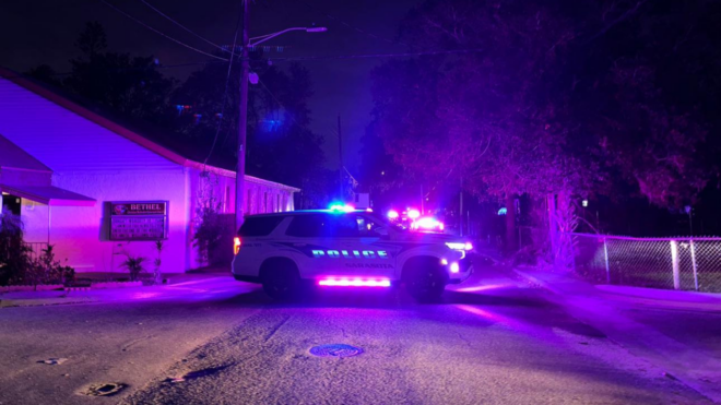 Sarasota police car with lights on at night