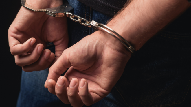 a man's hands in handcuffs