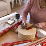 Woman wrapping a round box