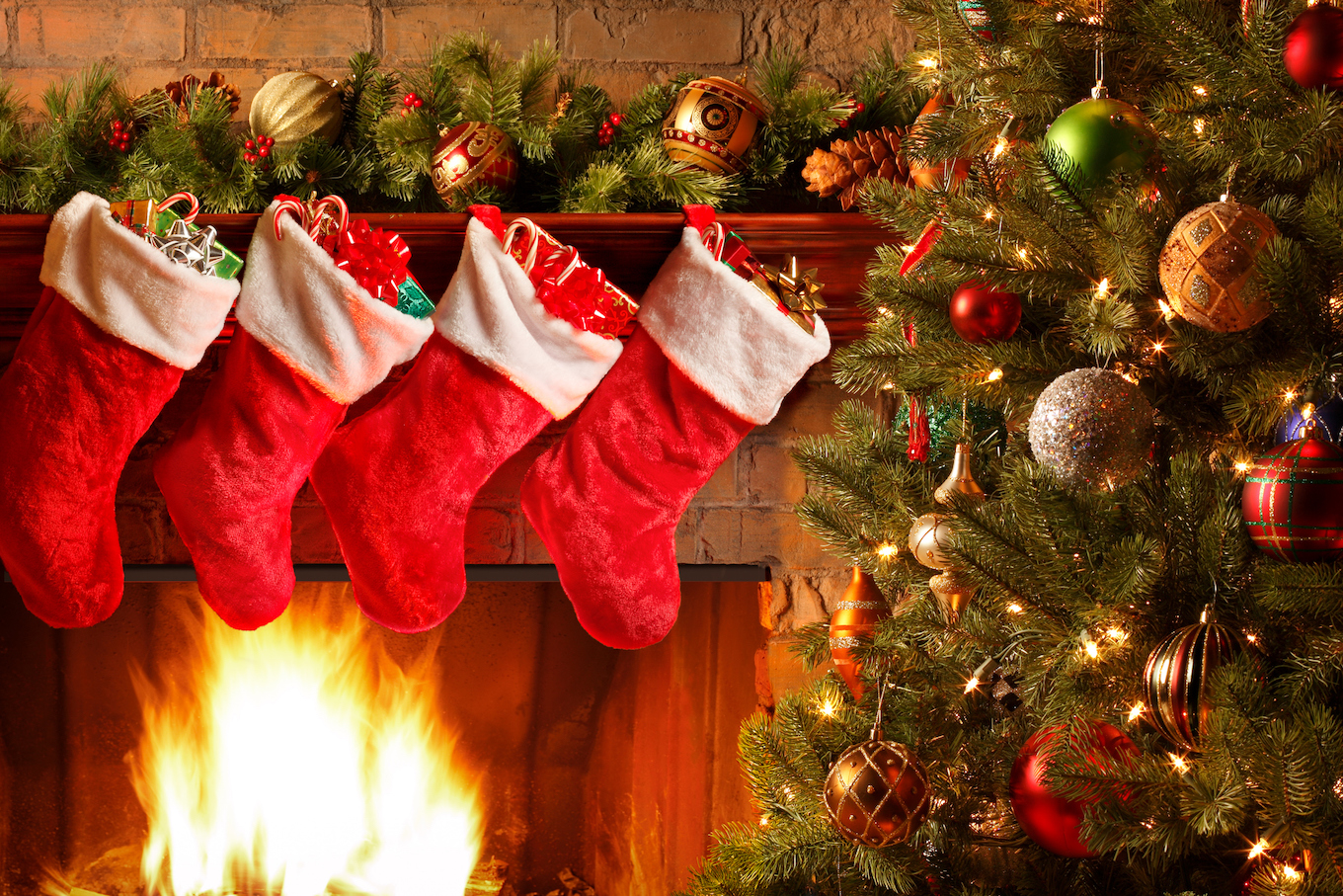 Christmas Stockings Hang From The MAntel Of A Fireplace