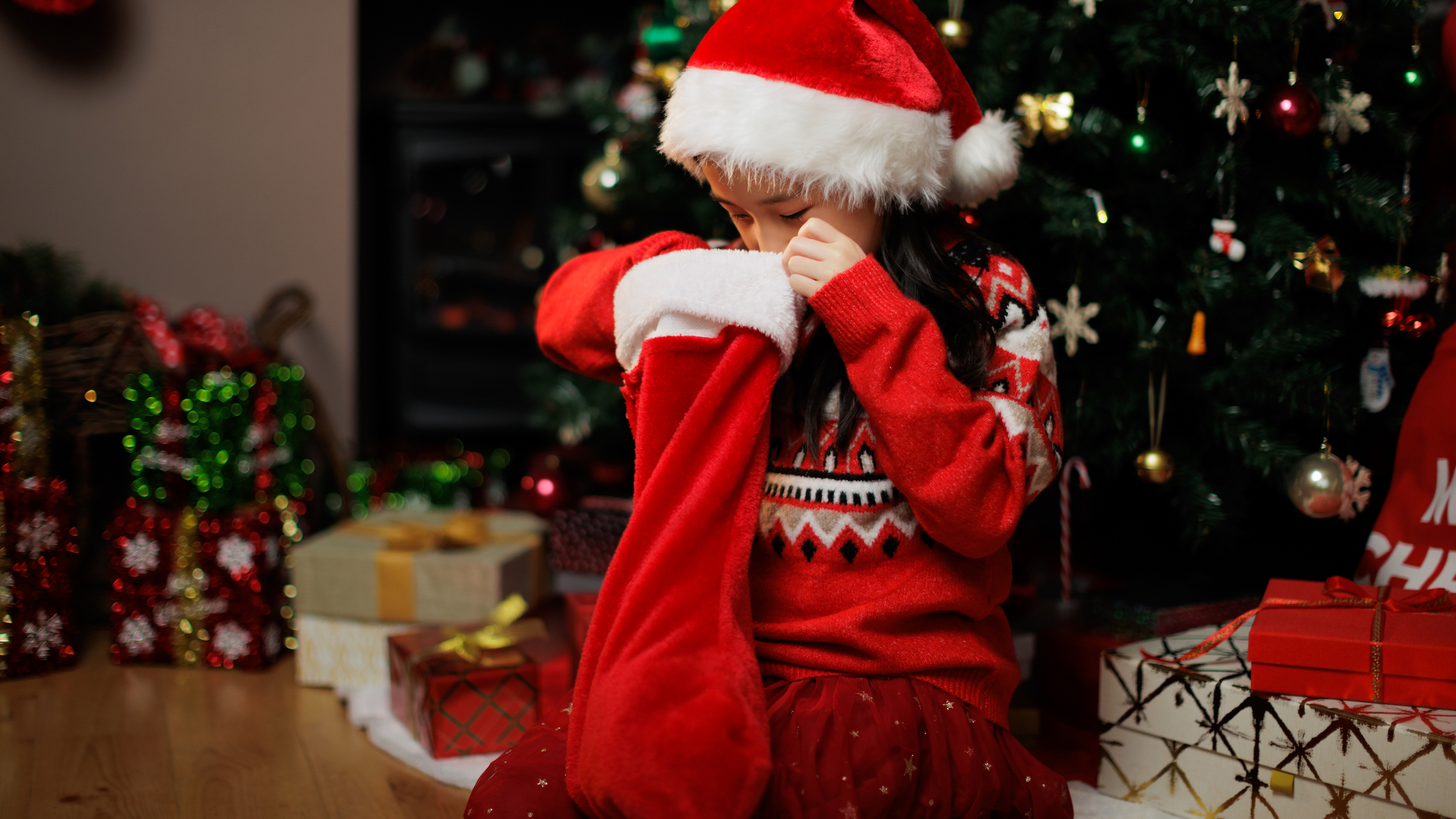 Girl looking in a Christmas stocking