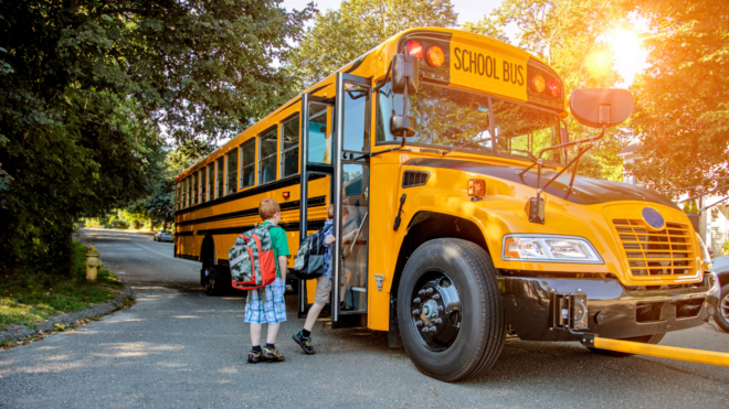 kids getting on school bus