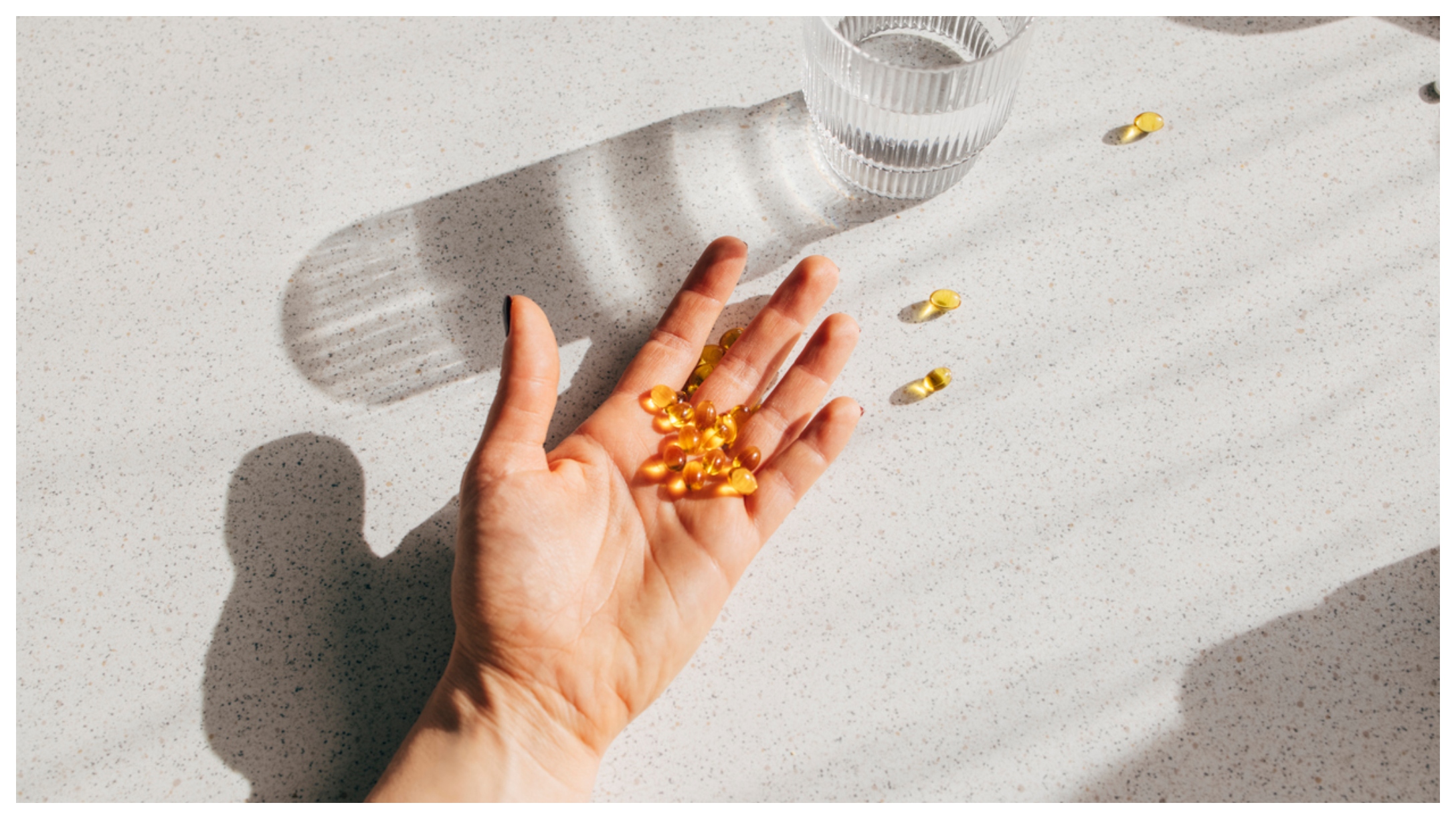 hand holding Vitamin D pills