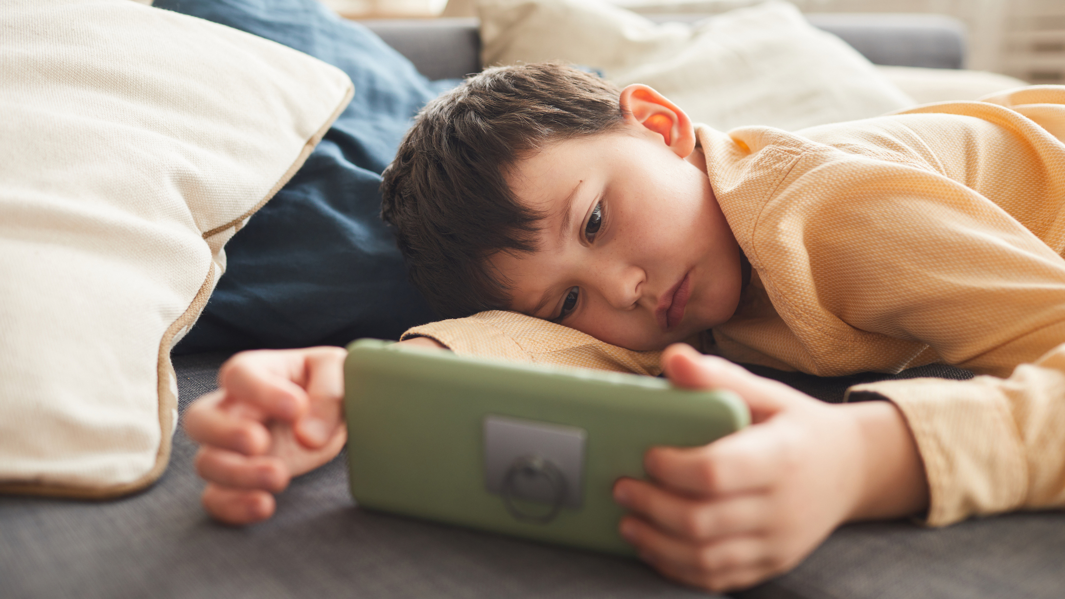 Bored Little Boy Using Smartphone