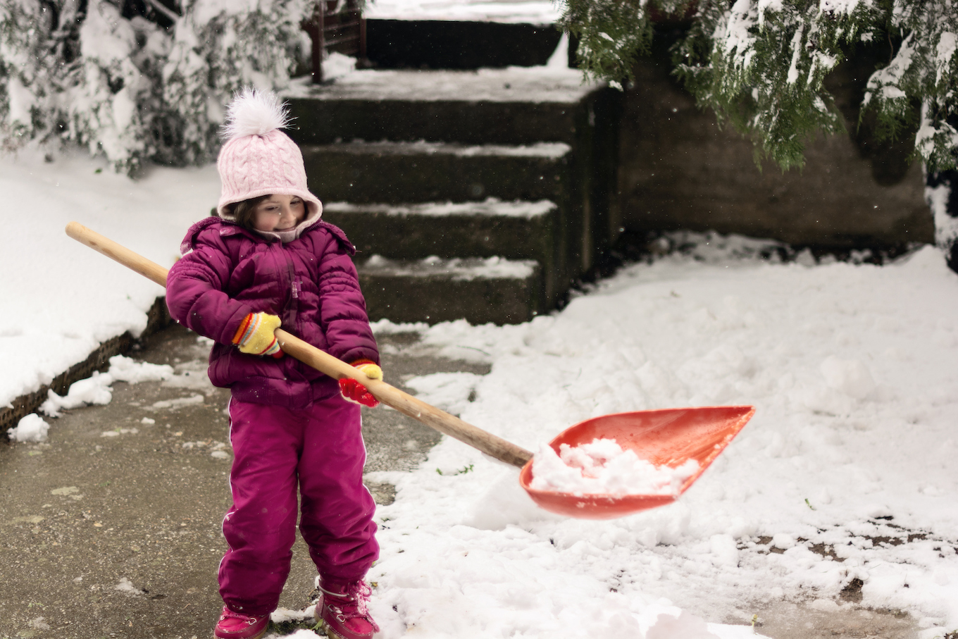 Girl shoveling snow