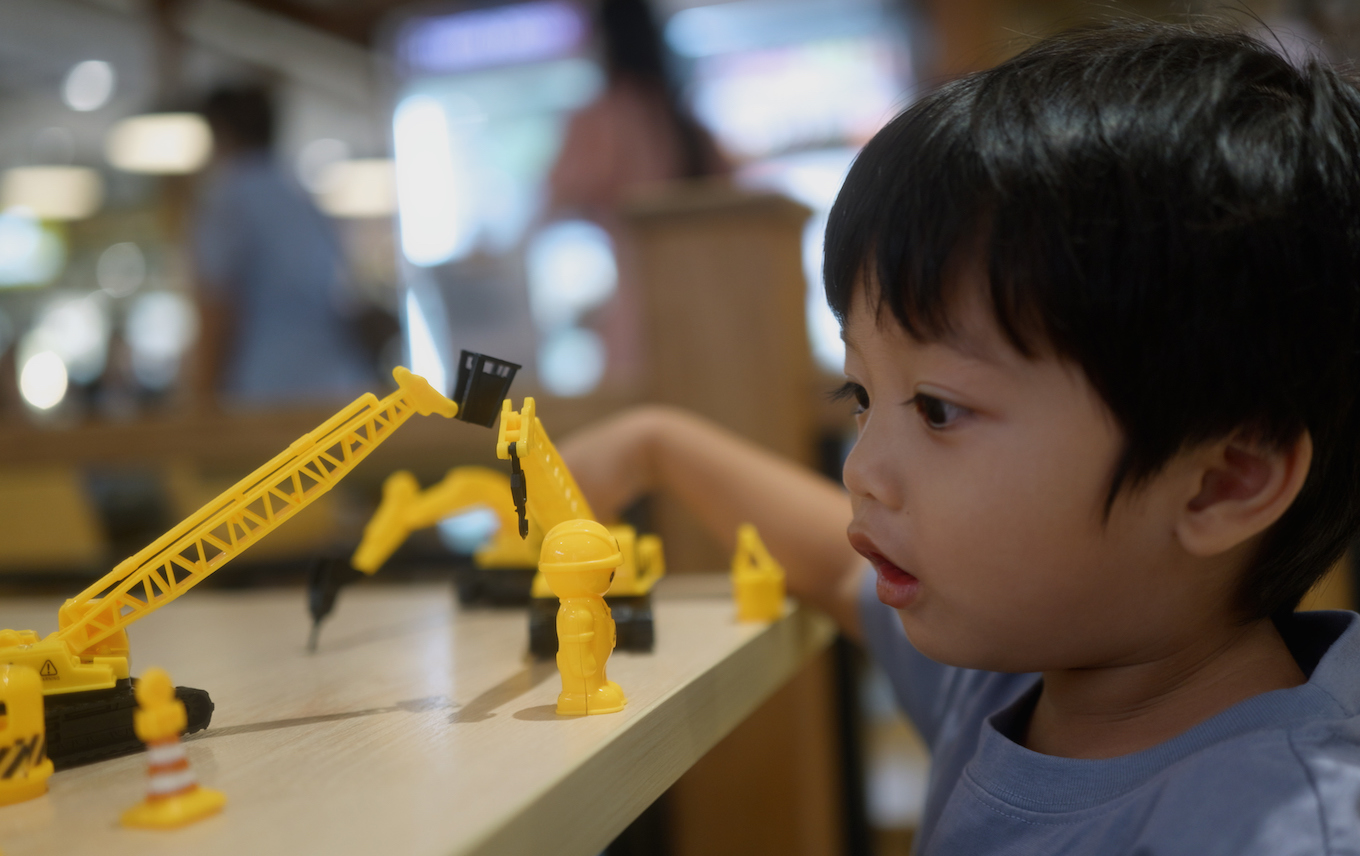Kid playing with toys at a table