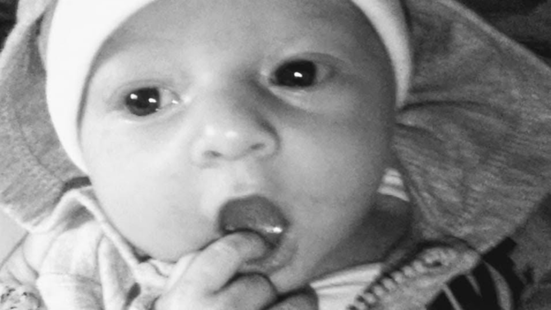 a black and white photo of infant Ki'arri Winstead