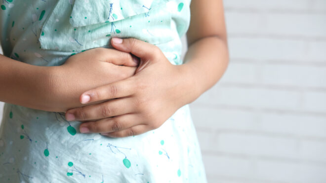 girl suffering stomach pain close up.